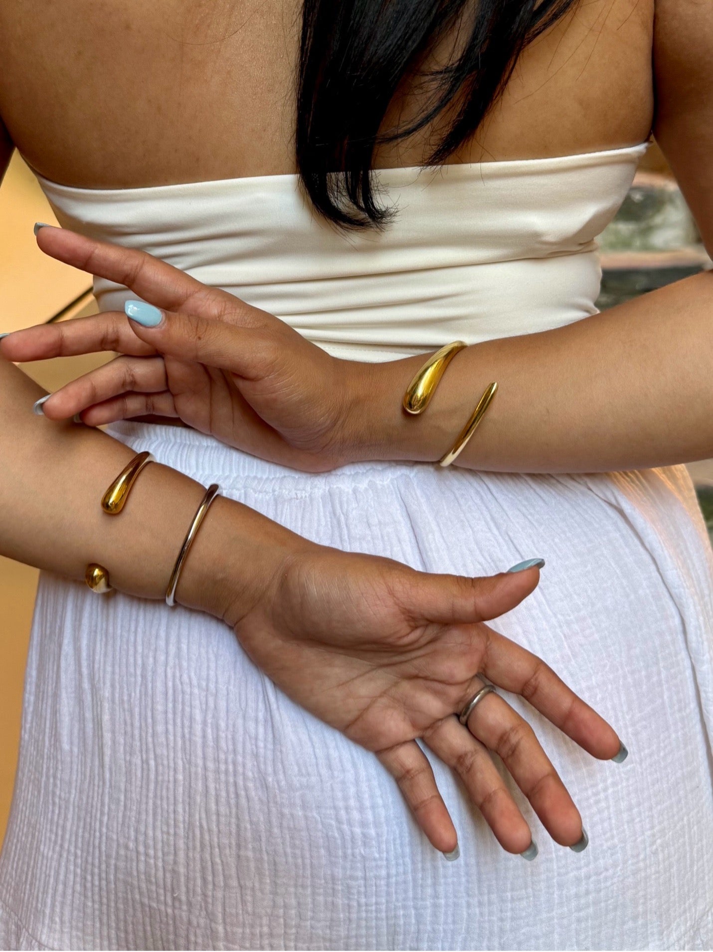 Handcrafted twisted adjustable cuff in 24K gold, brass, or silver. Sustainable jewelry made in Kenya.